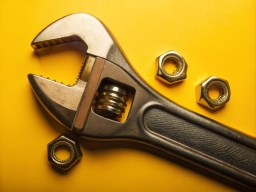 노란색 배경 위의 vector illustration wrench 와 nuts